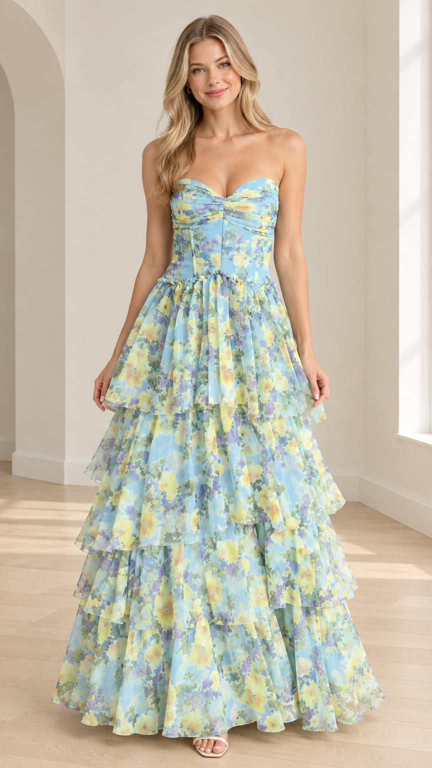 Front view of model wearing sky blue floral strapless tiered tulle maxi dress