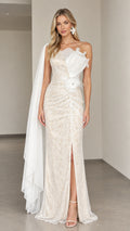Front view of woman wearing ivory one-shoulder lace evening gown with cape drape and pleated flower applique