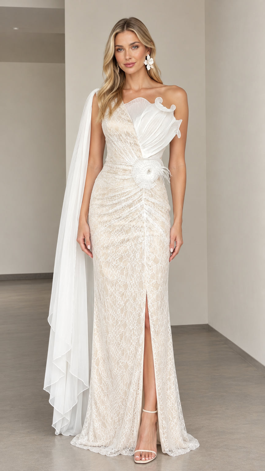 Front view of woman wearing ivory one-shoulder lace evening gown with cape drape and pleated flower applique