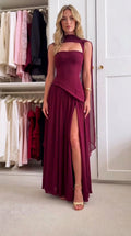 Front view of model wearing burgundy corset bodice maxi dress with neck drape and side slit