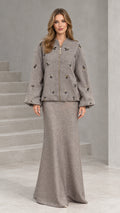 Front view of woman wearing taupe embellished zip jacket and matching maxi skirt set