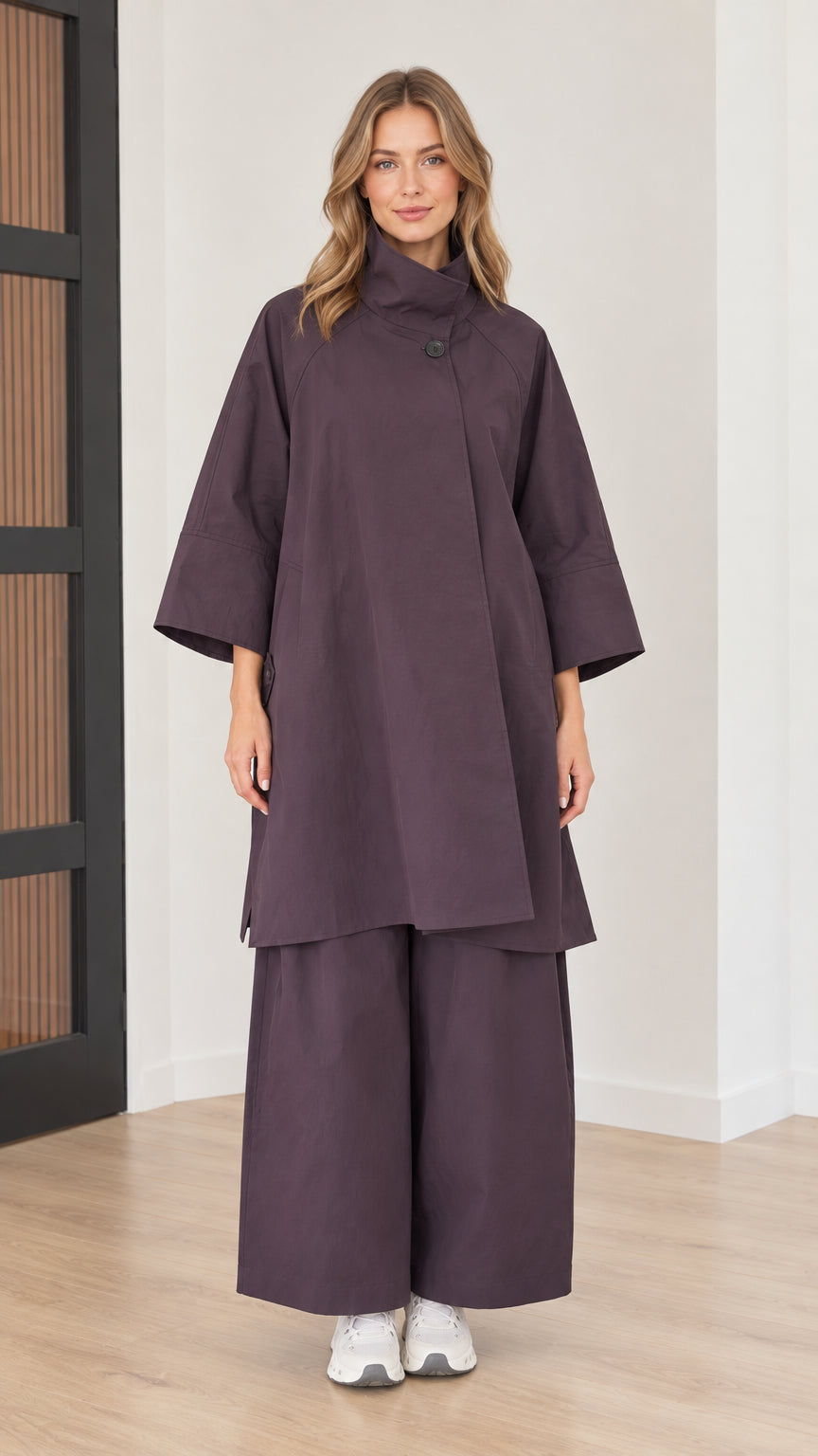 Women's two-piece set in eggplant purple featuring longline high-neck tunic top and wide-leg pants front view