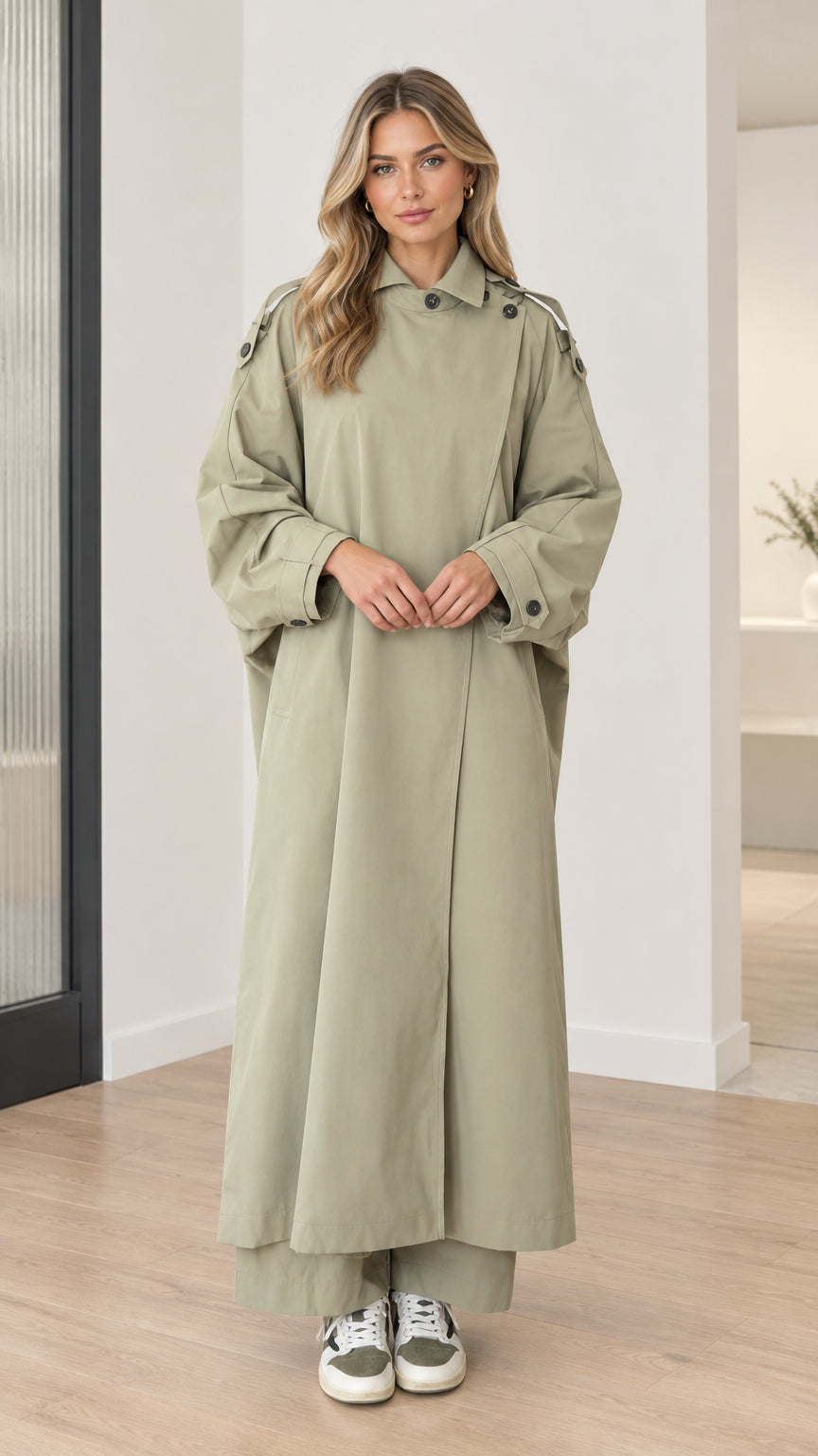 Front full-length view of model wearing sage green oversized maxi duster trench coat