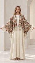 Front view of cream floral embroidered abaya maxi dress with fringe detail
