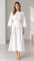 Front full view of woman wearing white belted maxi dress with crochet lace trim