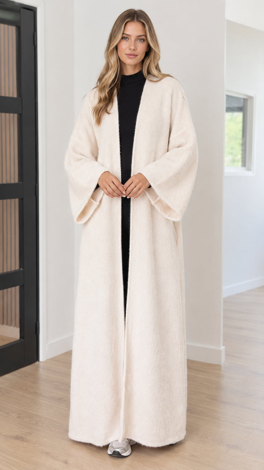 Front view of model wearing full-length cream textured bouclé open-front duster coat