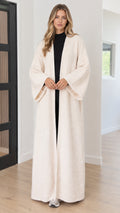 Front view of model wearing full-length cream textured bouclé open-front duster coat