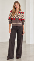 Front full view of woman wearing mocha brown chevron heart zip-up knit cardigan with wide-leg jeans
