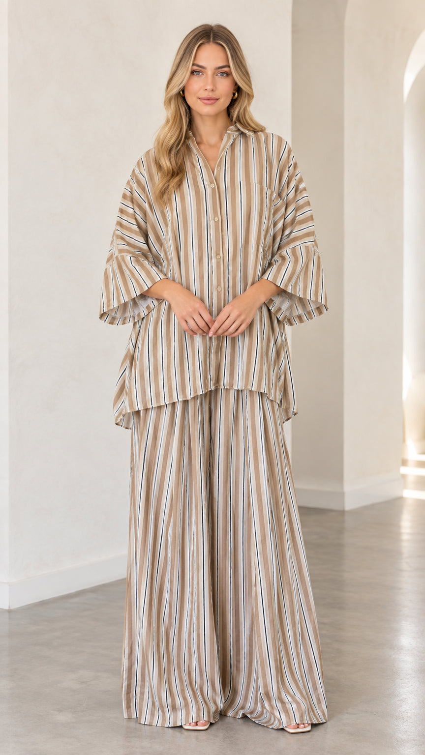 Front view of woman wearing beige striped oversized tunic shirt and wide-leg matching pants set