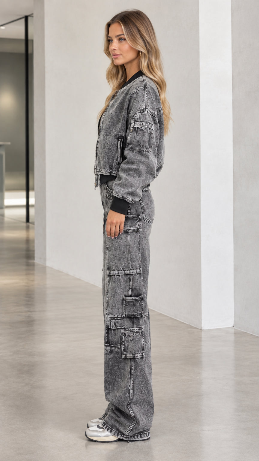 Side profile view of model wearing washed charcoal denim two-piece cargo set