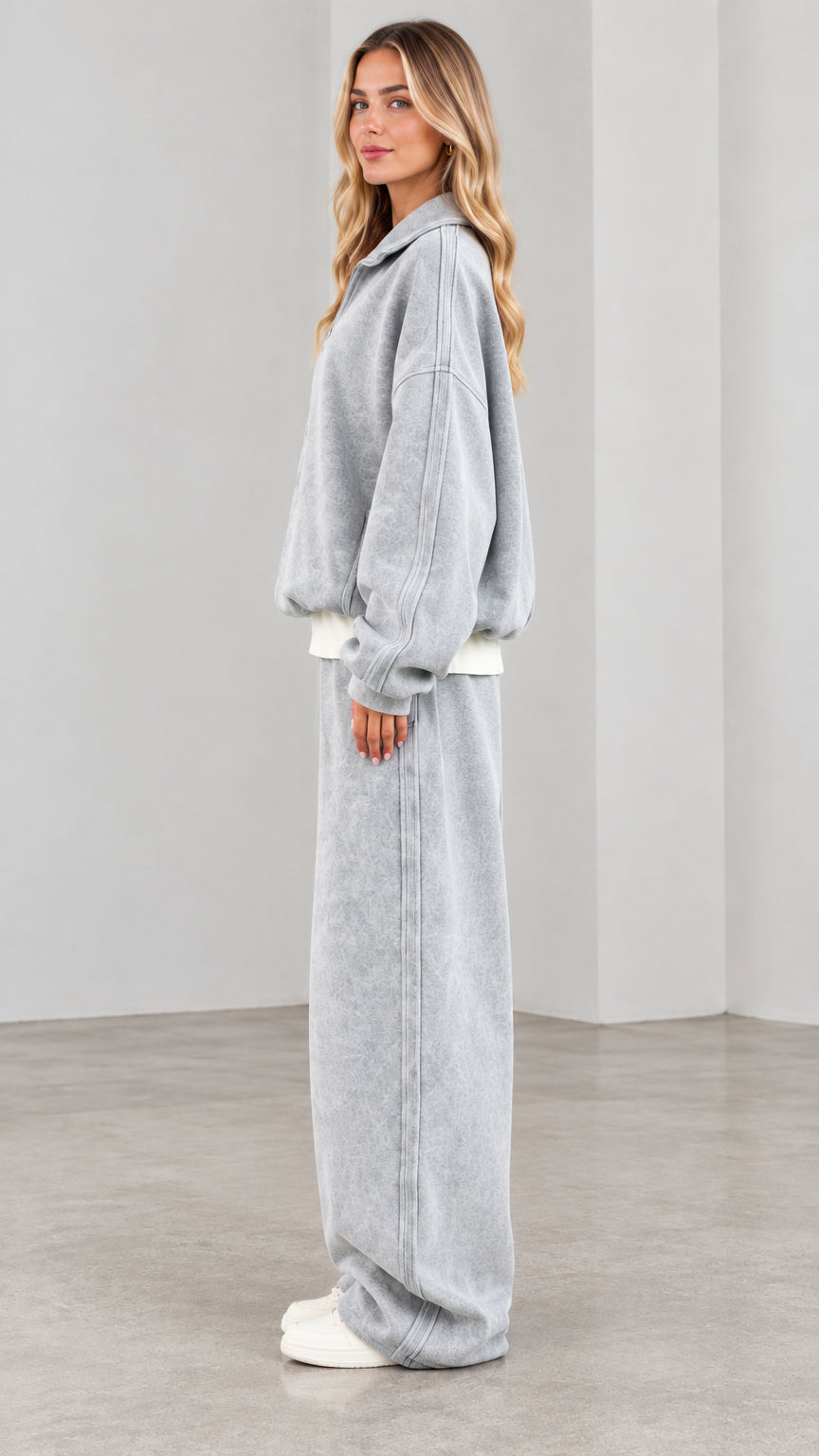 Side view of model wearing washed grey 2-piece lounge set with relaxed wide-leg trousers