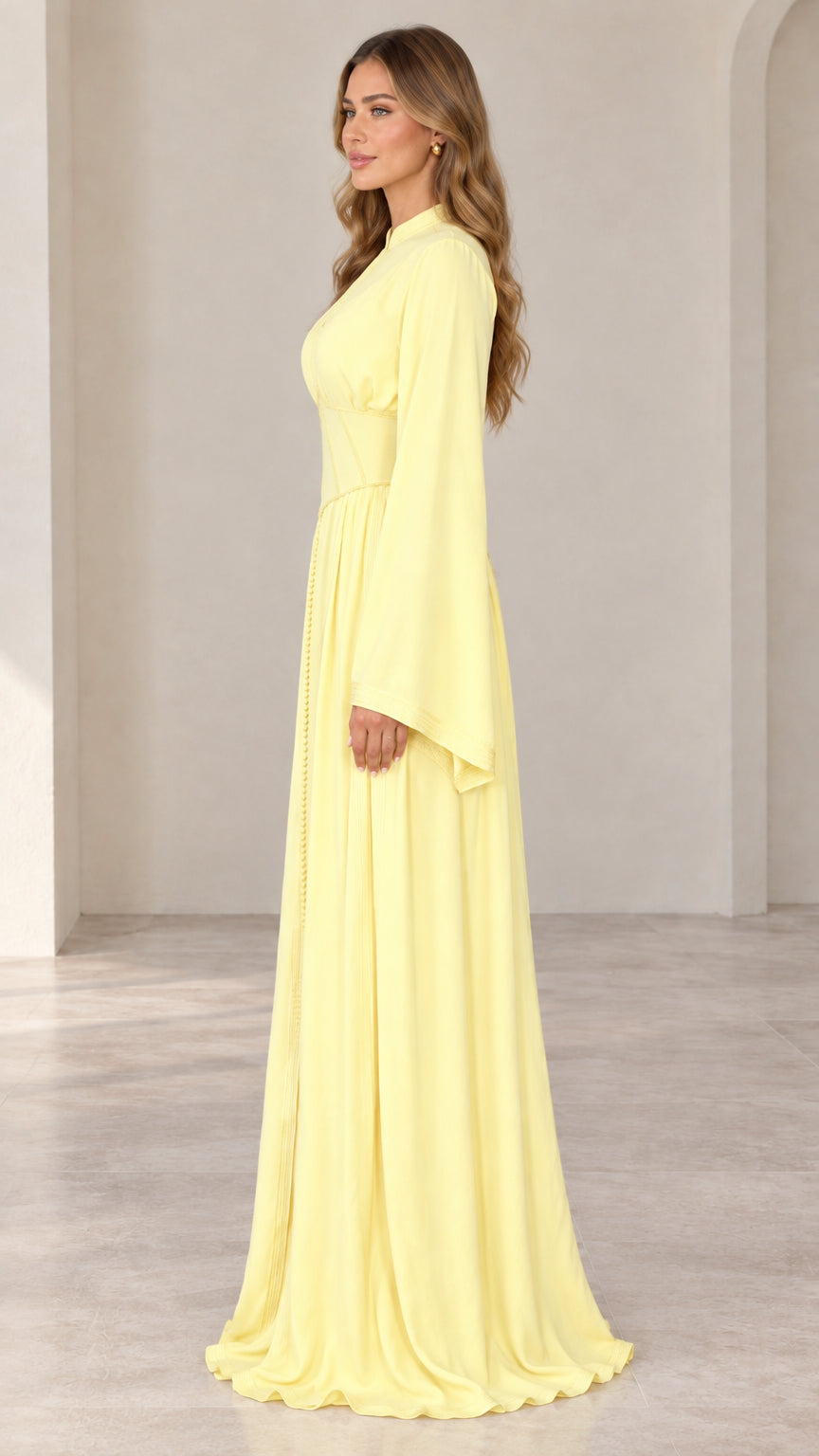 Pastel yellow evening maxi dress side view showing sweeping floor length