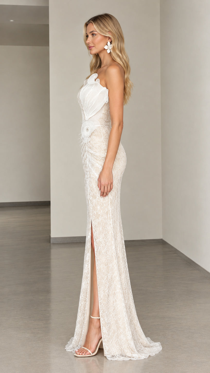 Side profile of woman in ivory fitted lace gown showing side slit and shoulder drape