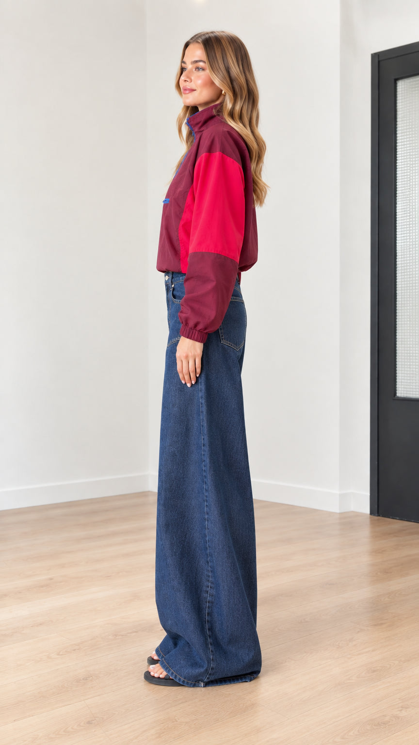 Side profile of woman in burgundy color-block lightweight windbreaker jacket