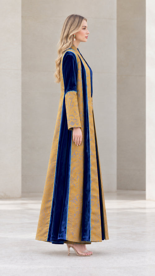 Side profile view of Mustard and Royal Blue velvet long duster coat and trousers