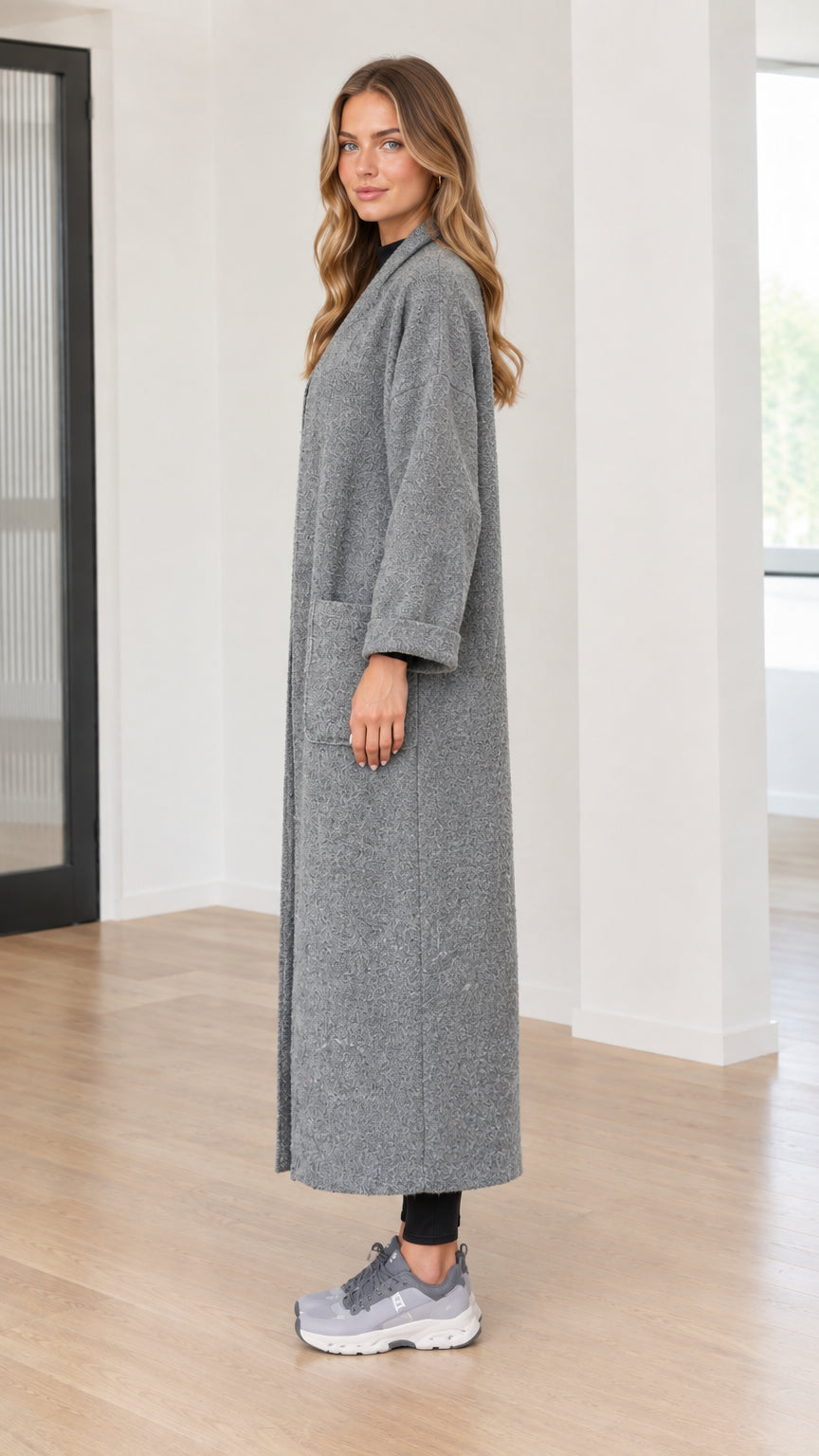 Side profile view of model wearing grey maxi bouclé duster coat
