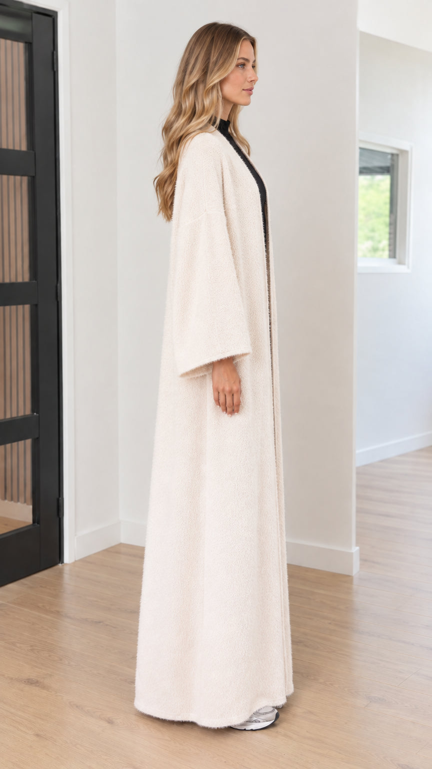 Side profile view of cream maxi duster cardigan showing wide sleeve design