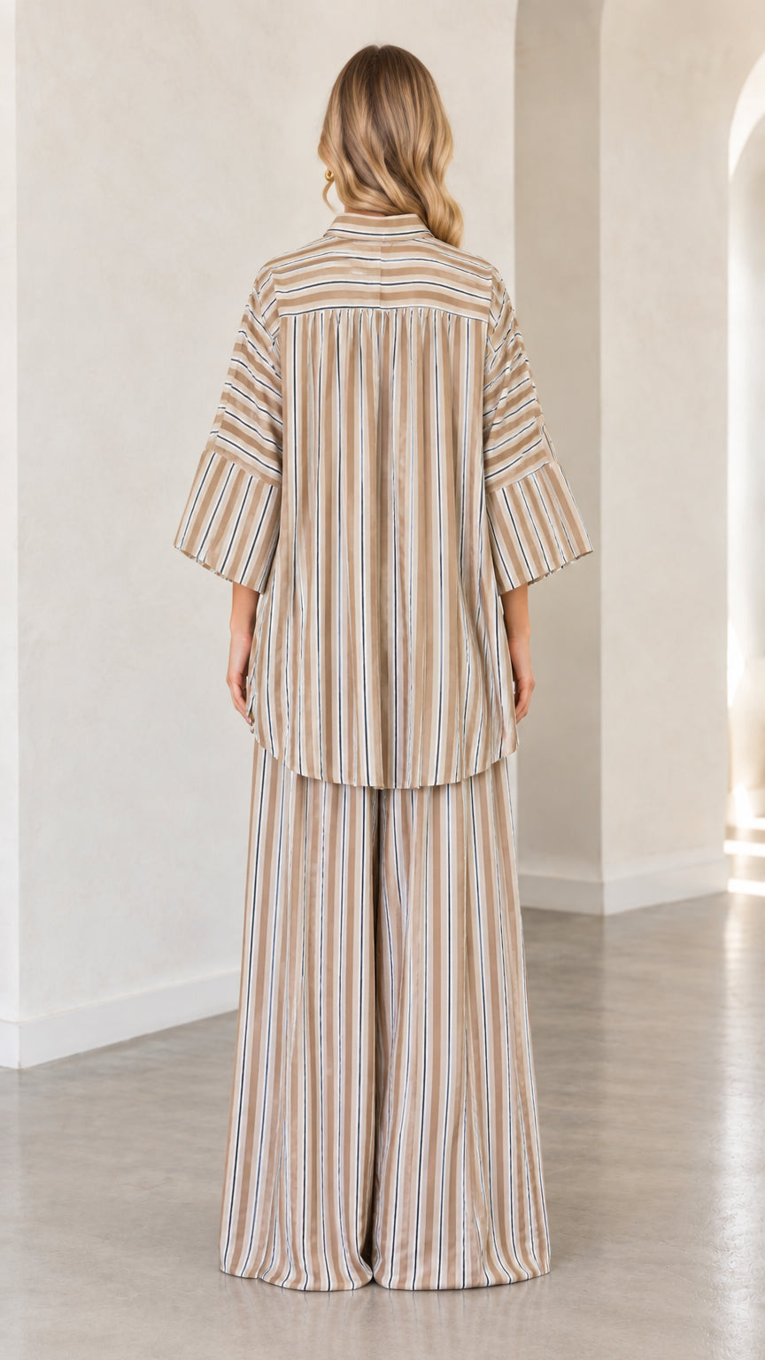 Back view of beige striped loose button-down shirt and palazzo pants set