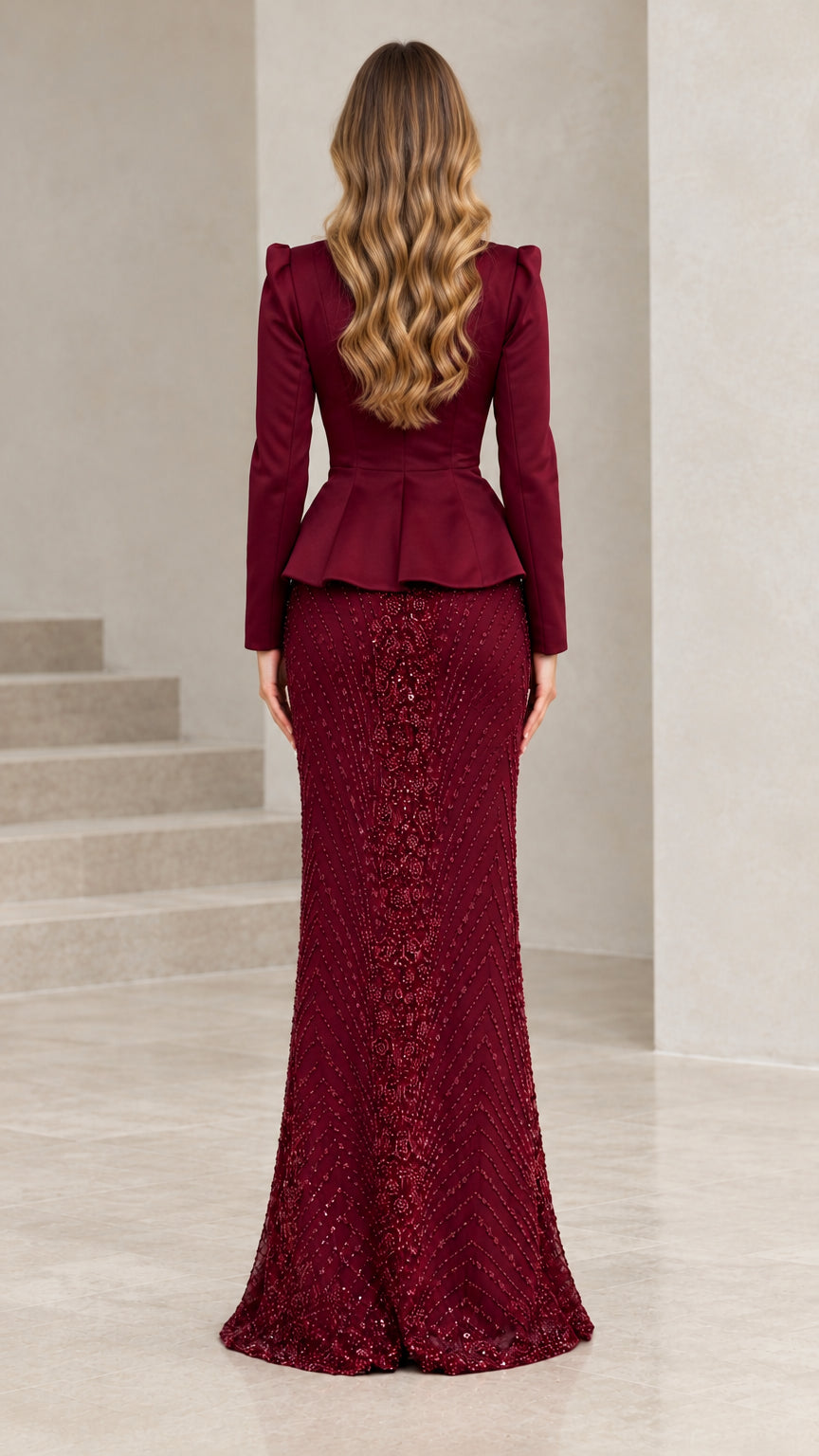 Back view of model showing burgundy peplum blouse and floor-length sequin evening skirt