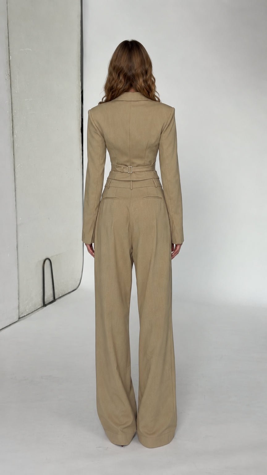 Back view of beige pant suit set showing fitted cropped blazer and wide leg trousers