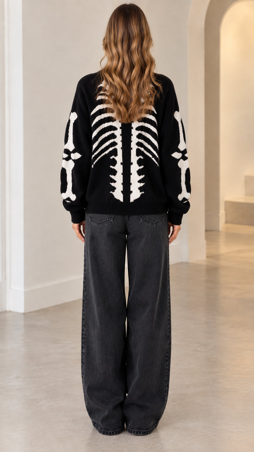 Back view of model wearing black skeleton cardigan showing full ribcage knit pattern