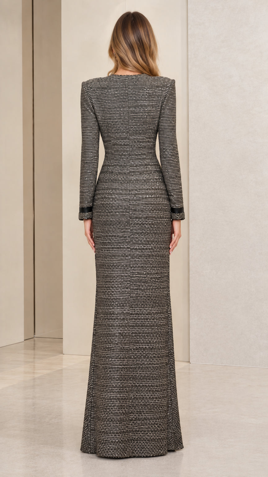 Back view of woman showcasing the sleek fit and tailored structure of the charcoal grey maxi dress