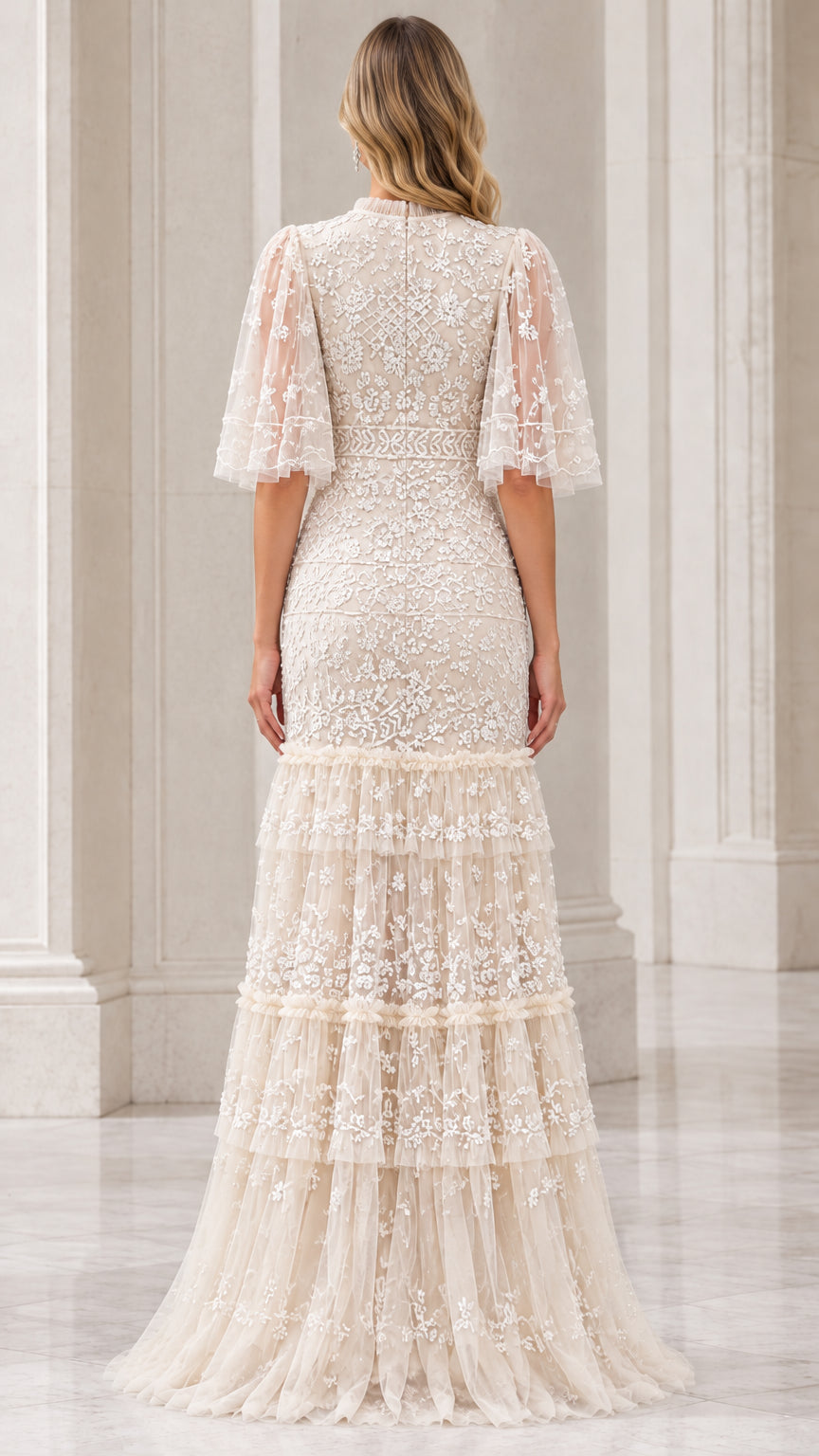 Back view of champagne embroidered tiered evening dress with sheer flutter sleeves