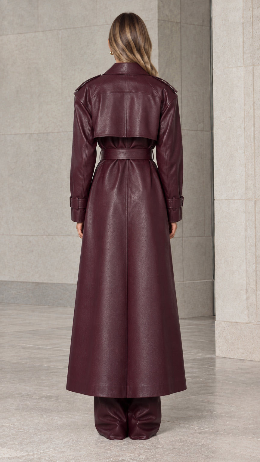 Back view of burgundy faux leather trench coat showing the classic back flap detail