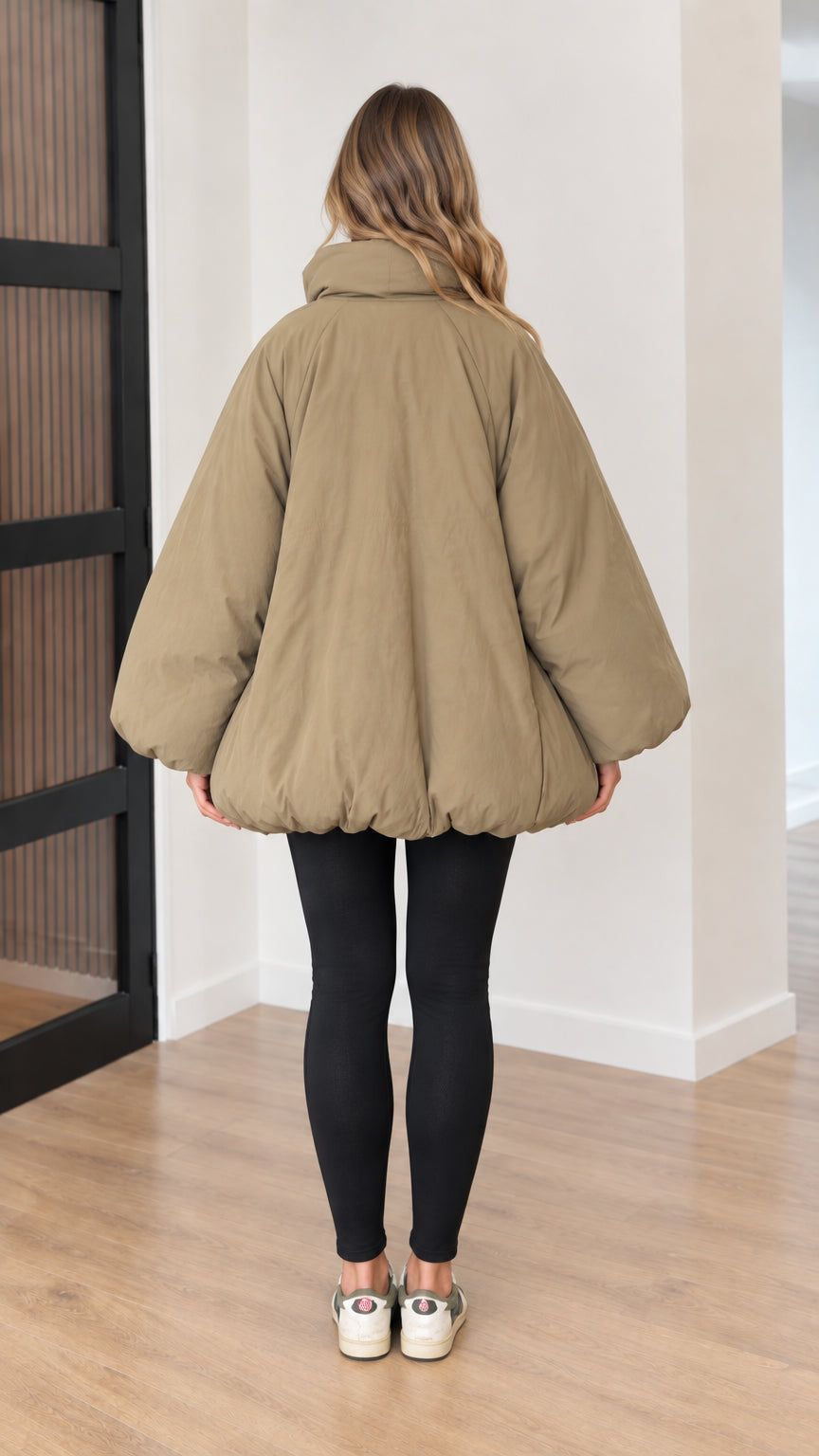 Back view of model wearing relaxed khaki cocoon puffer jacket