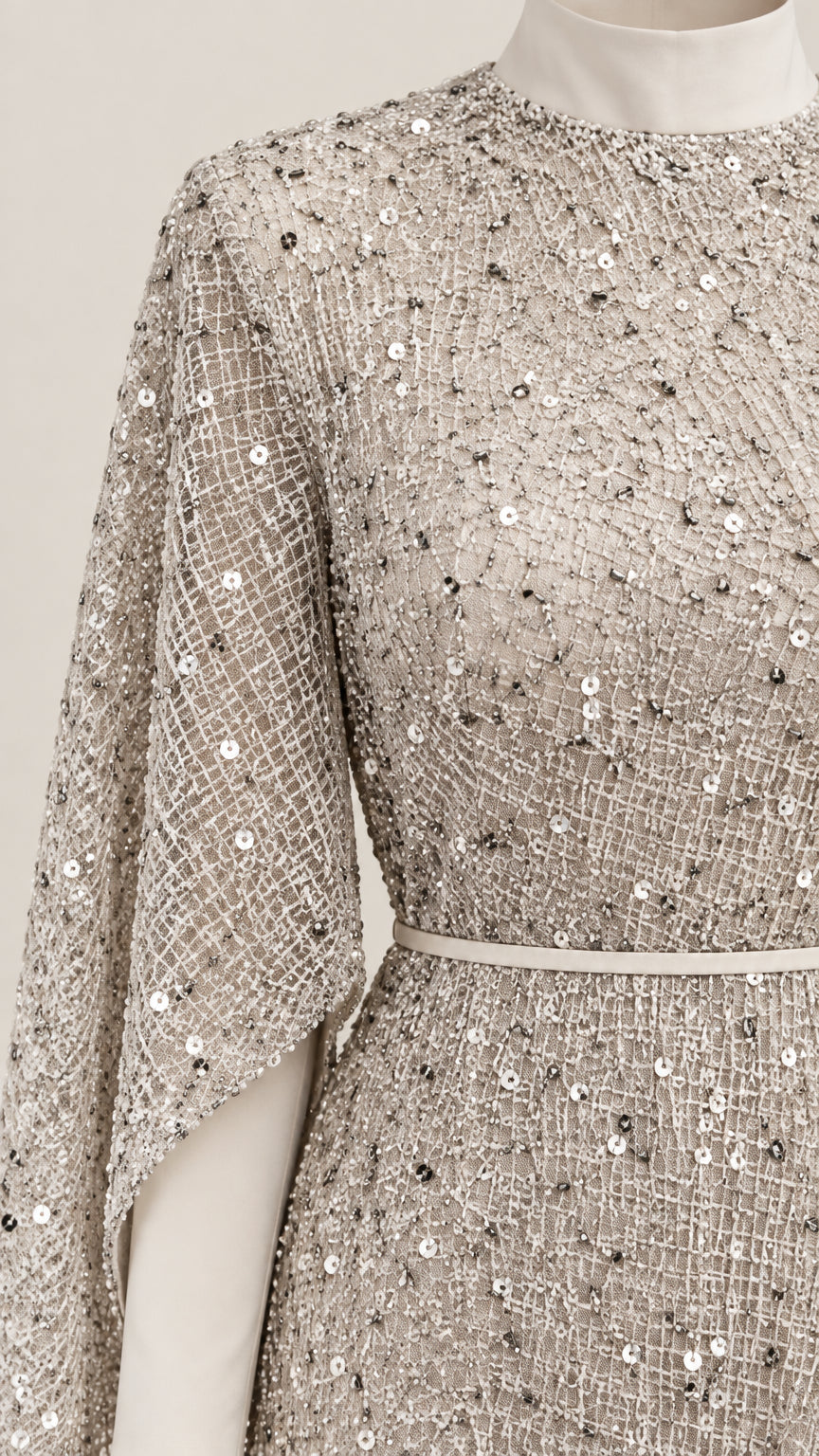 Close-up detail of champagne grid mesh sequin embroidery and slim waist belt