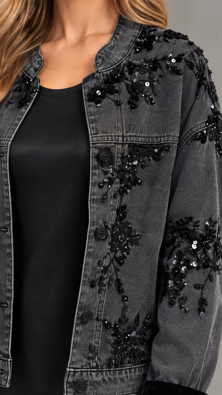Close-up detail of black denim jacket with sequin floral embroidery and button front