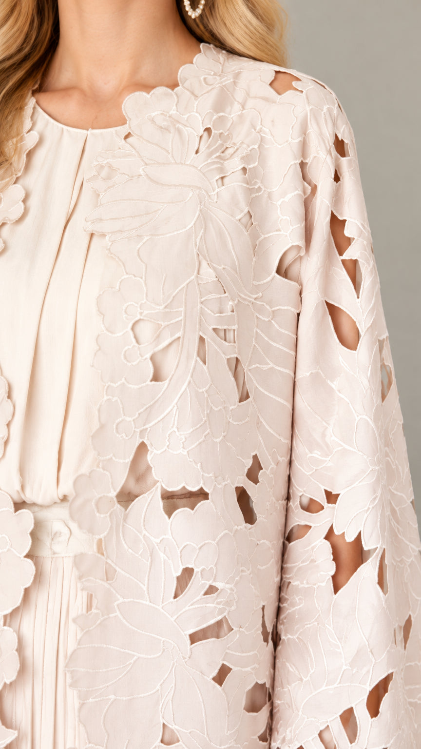 Close-up detail of blush pink floral cutout lace embroidery and inner dress neckline