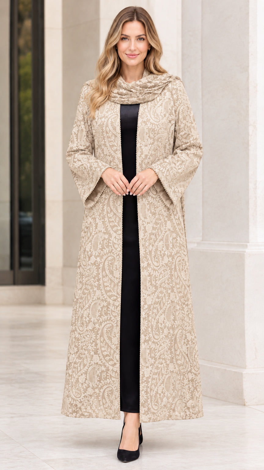 Front full-length view of woman wearing champagne beige paisley jacquard maxi duster coat